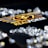 A collection of sparkling, clear gemstones surrounds a dark surface featuring the prominent logo and text 'Real Poker.' The logo design includes gold and white elements set against a black background.